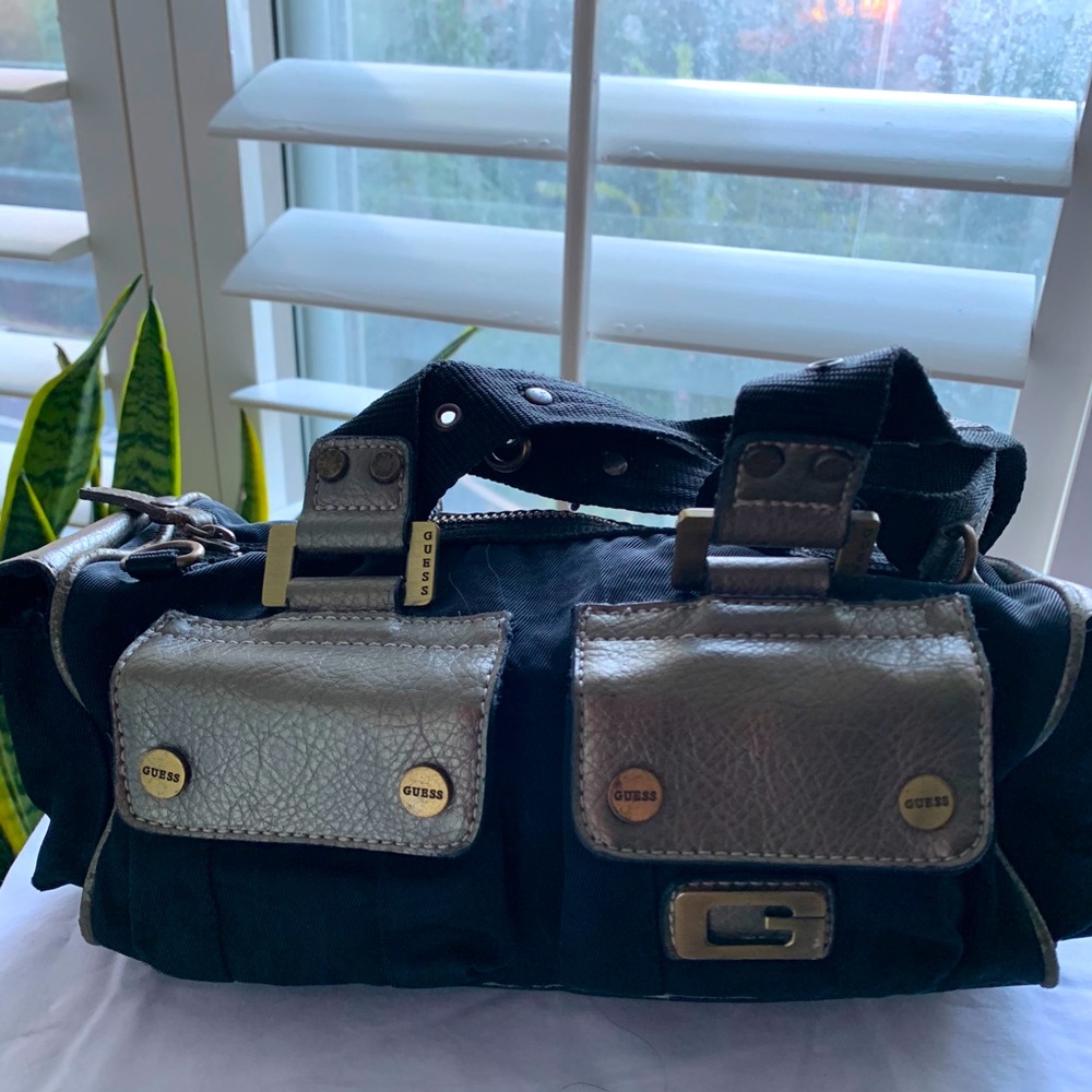 Guess mini tote.Black W/gold colored pockets.